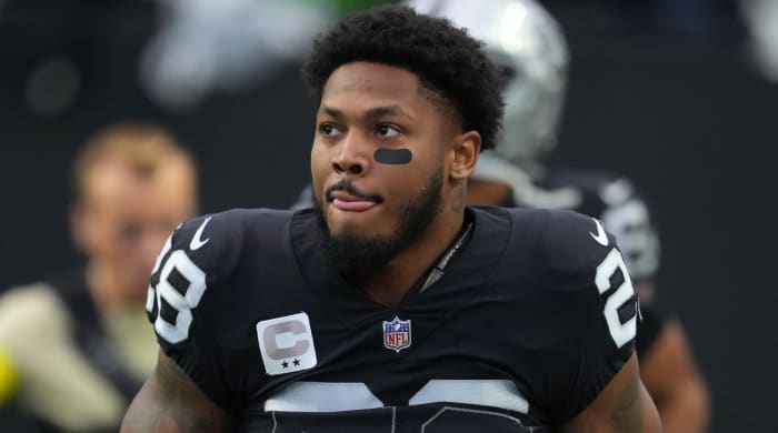 Raiders running back Josh Jacobs runs onto the field before a game.